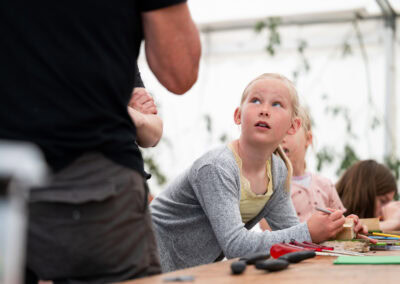 Woodsculpture Børn i et kreativt værksted med værktøj og materialer.