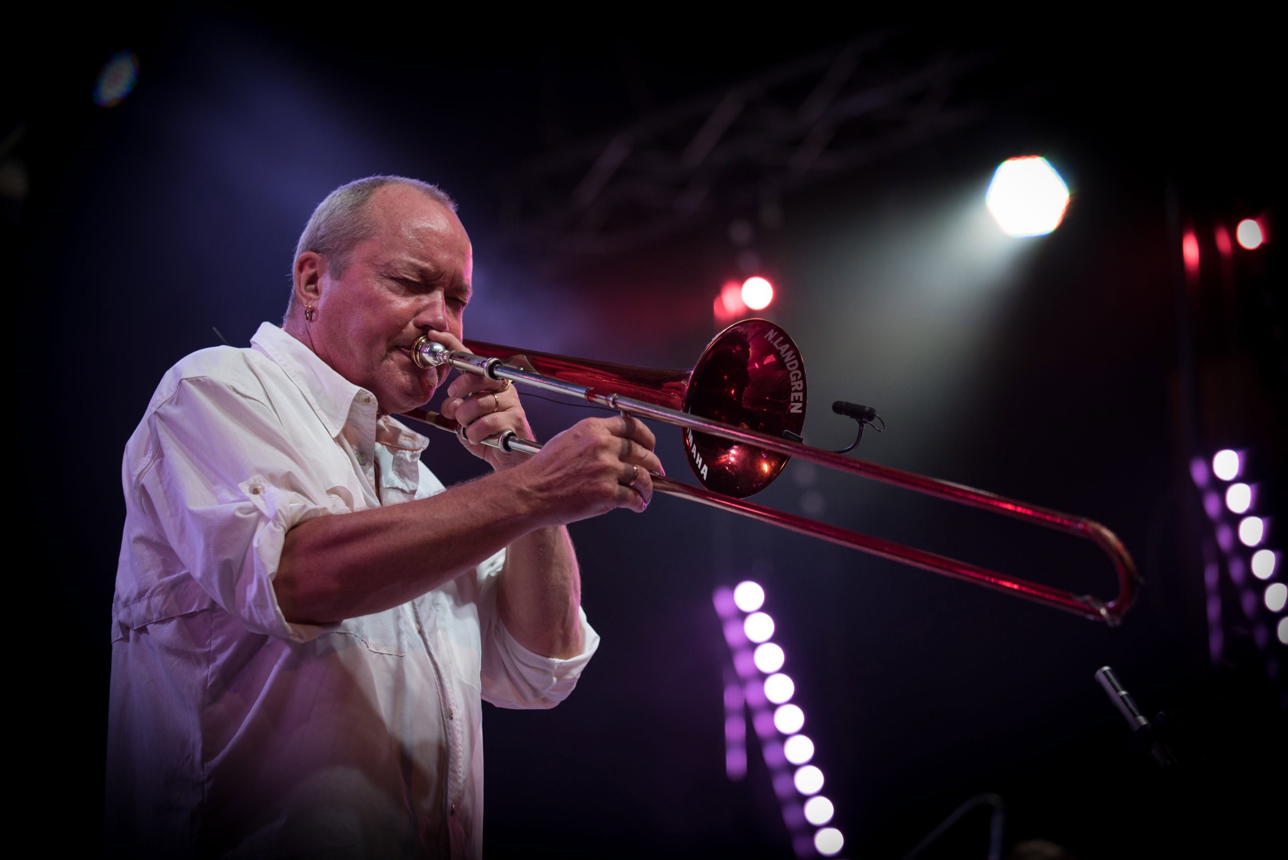 Musiker spiller trombone under koncert med fokus på musik og følelser.
